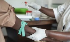 African nurse is drawing blood