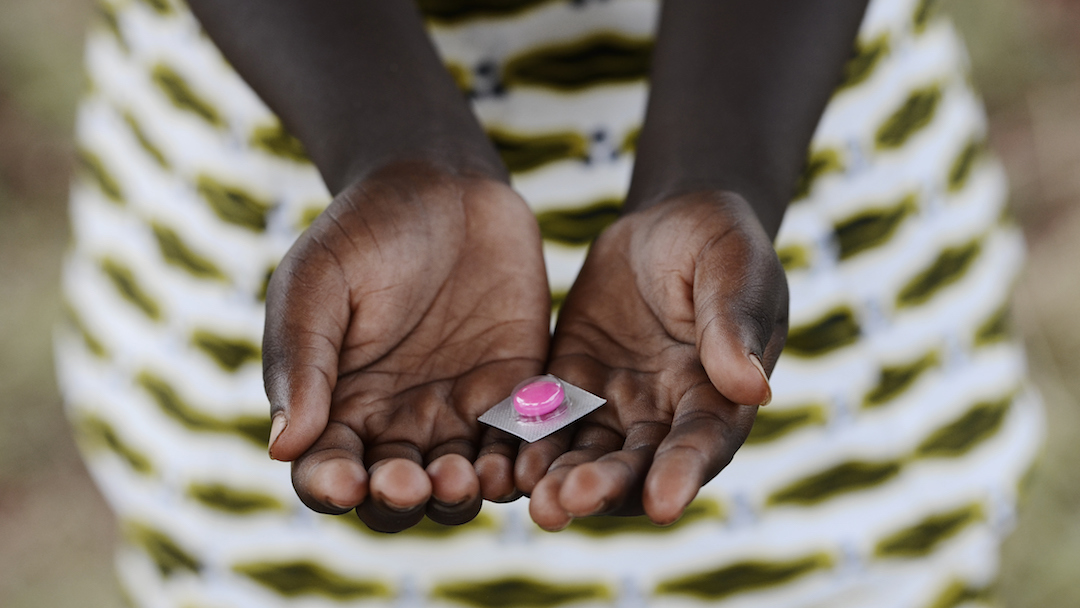 Black Girl Holding Pills Drugs to Cure Diseases in Africa